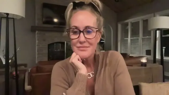 Blonde mature woman smiling during webcam show